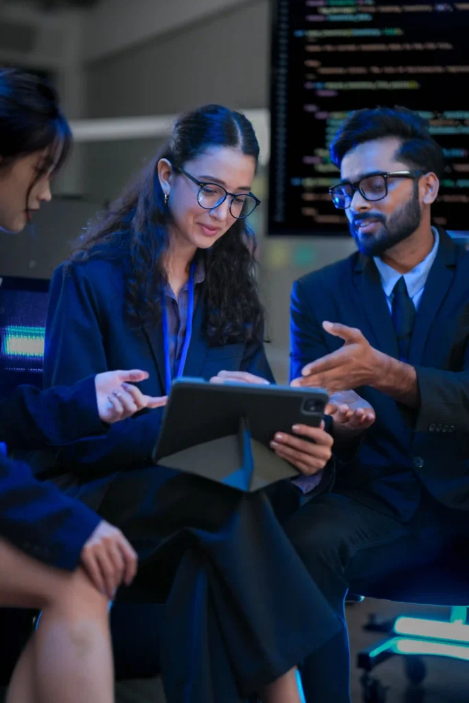 Business professionals reviewing tablet with code in background