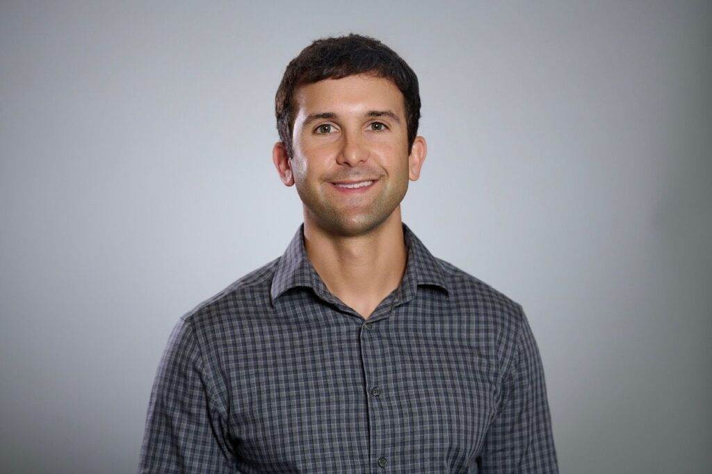 Smiling man in gray checkered shirt portrait