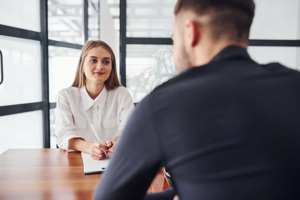 Woman interviewing man in modern office setting